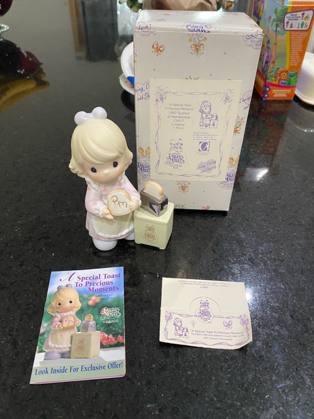 Precious Moments pastel pink and cream figurine holding a round plaque